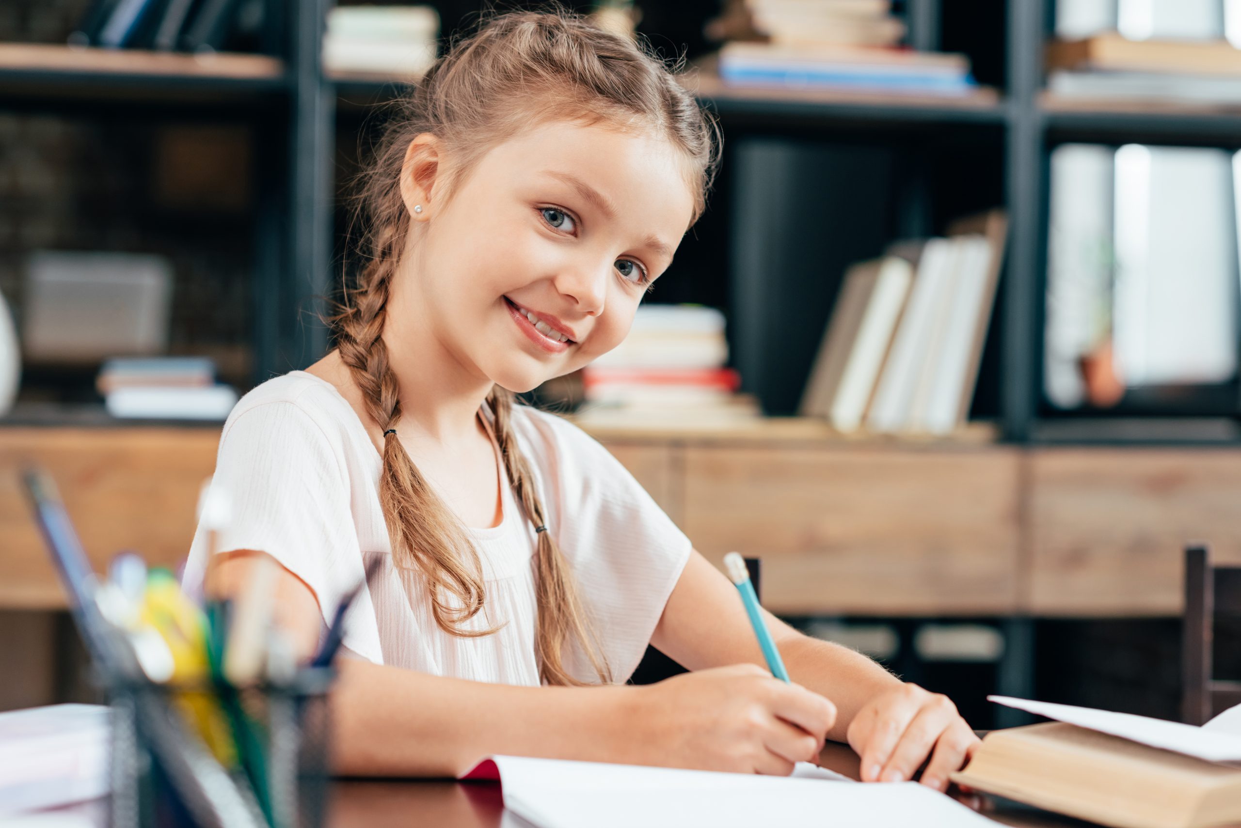 Canva-happy-smiling-little-girl-writing-homework